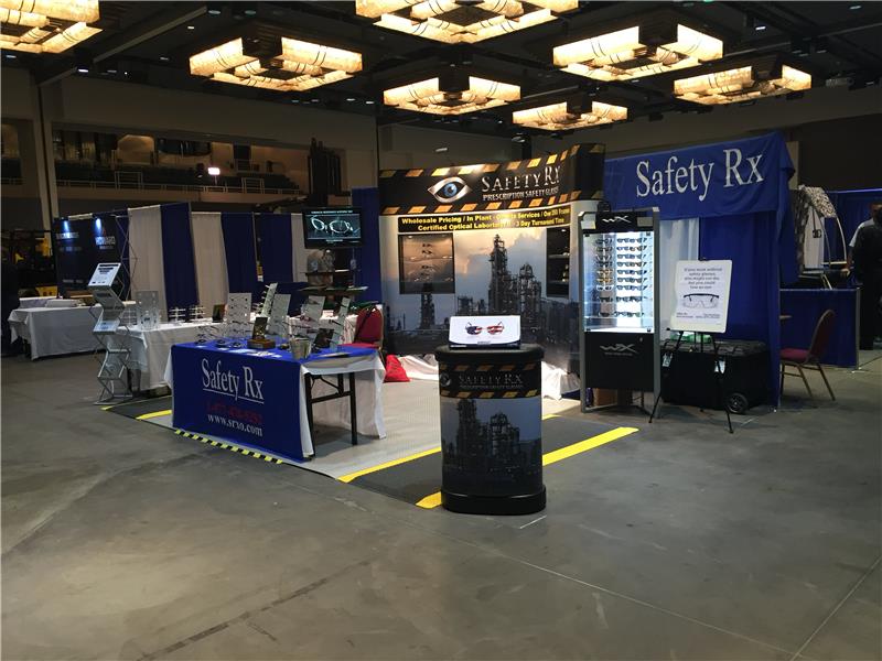 Safety Rx trade-show booth with frame displays, banners, and eyewear cases at an industry convention